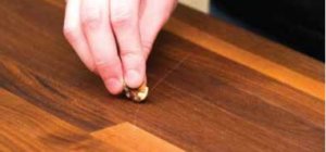 Rubbing walnut on a scratch on wood furniture